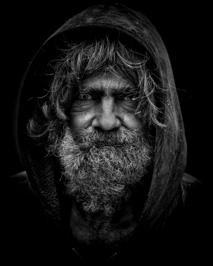 services-01 Emotive black and white portrait of an elderly man with a rugged appearance.